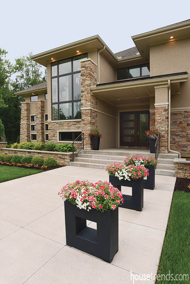 Unique planters dot walkway leading to front entry