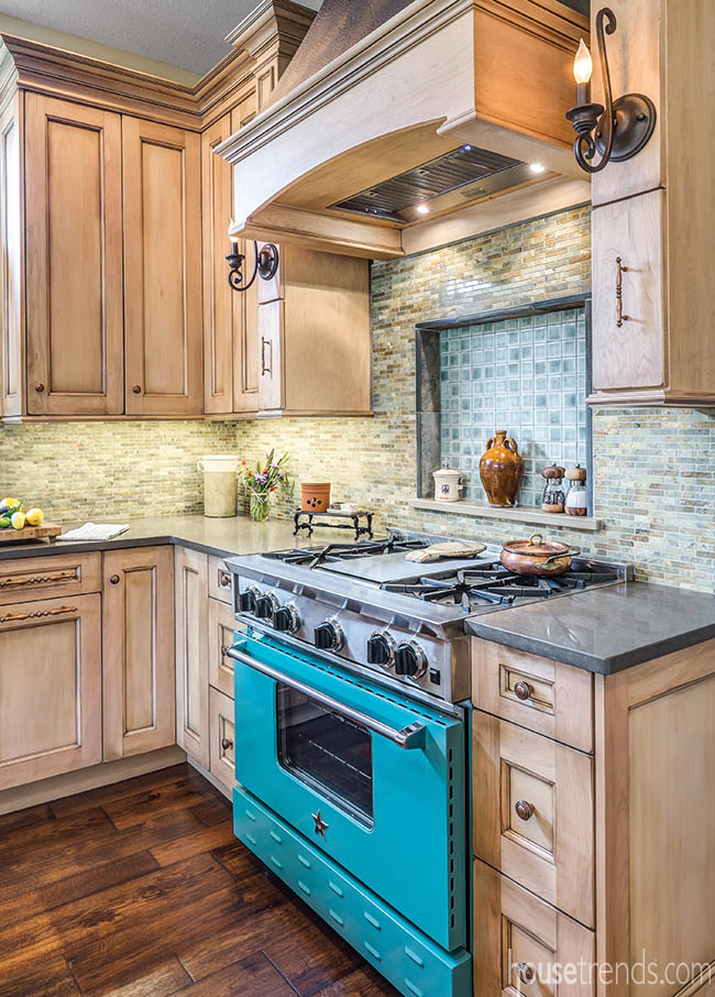 Teal gas range pops in a remodeled kitchen