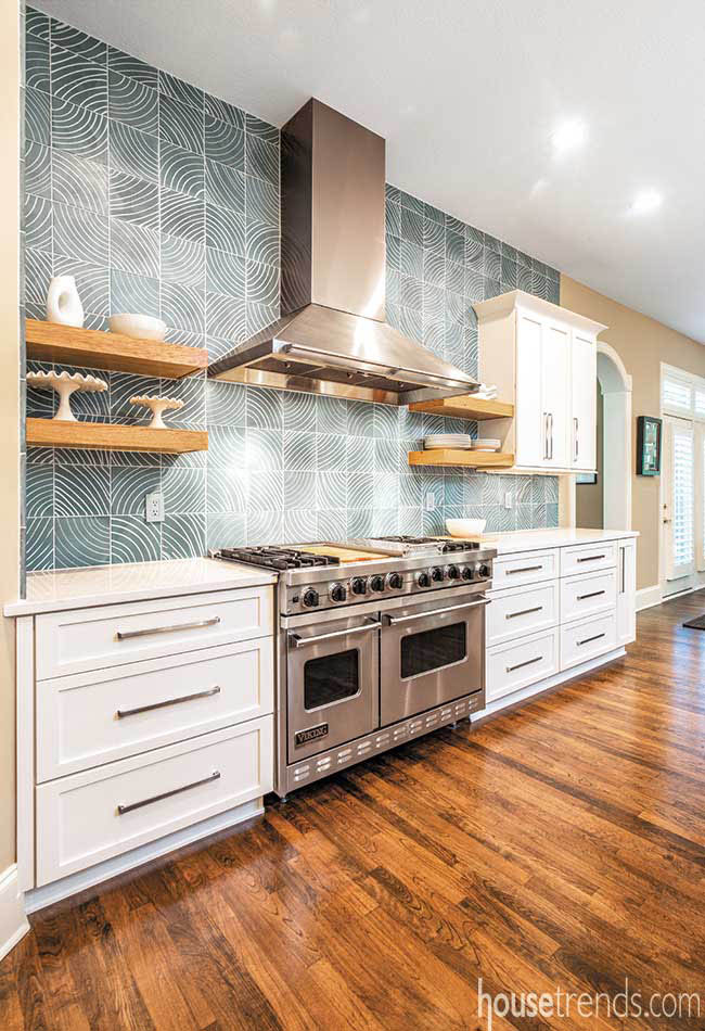 Floating shelves pop against a blue backsplash