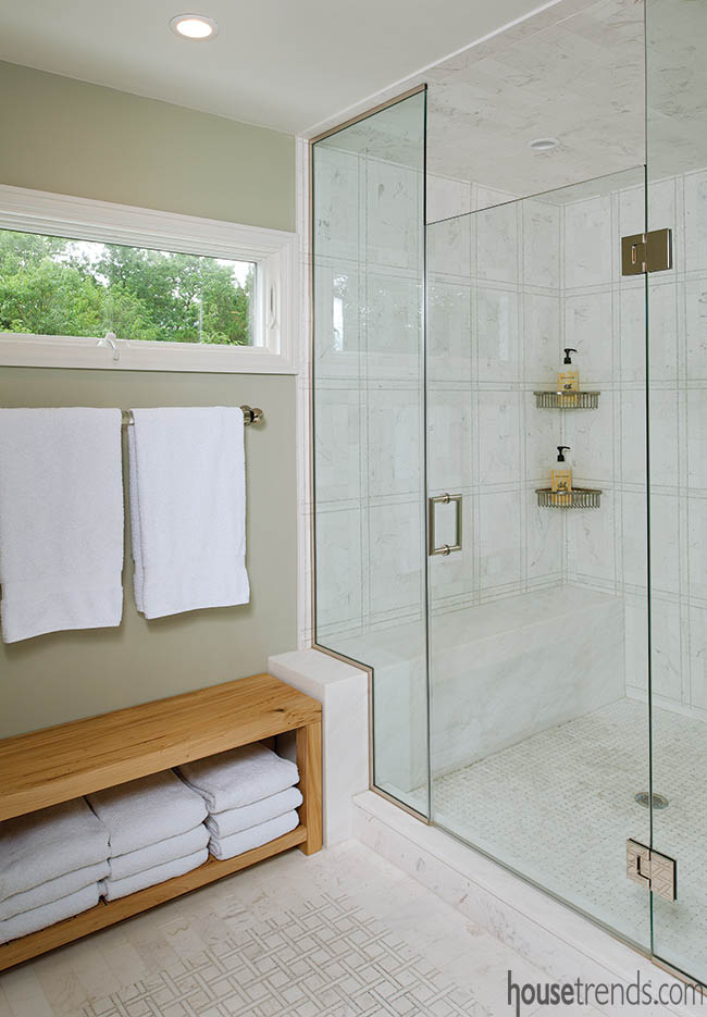 Wood bench offers storage for a master bath