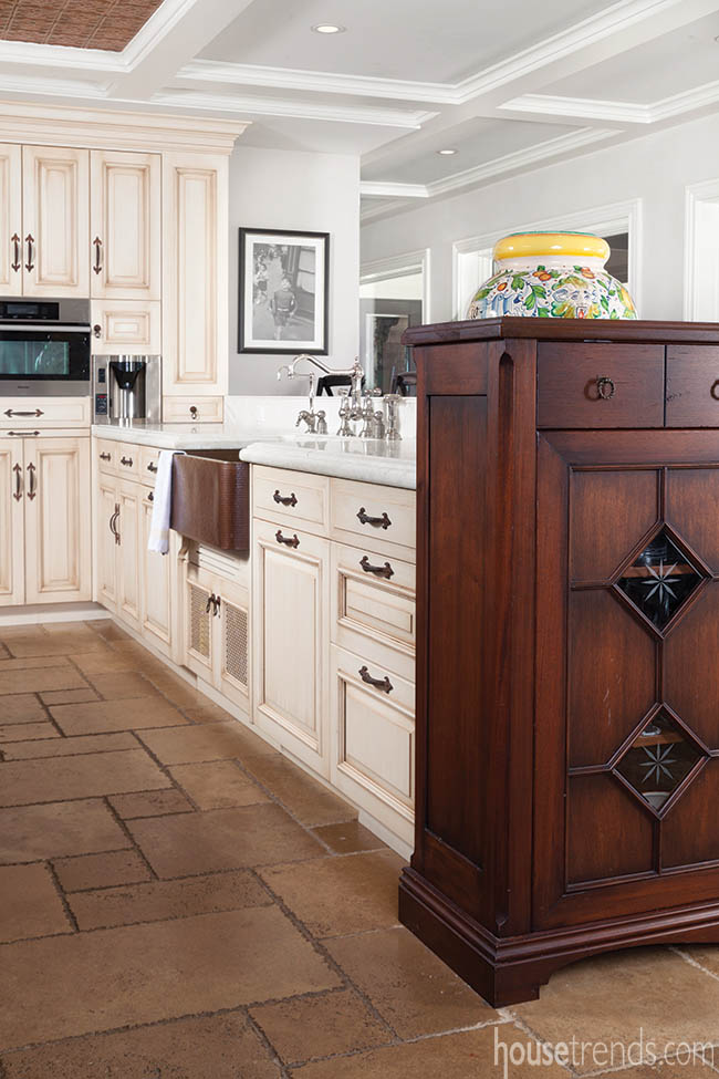 Copper sink contributes to a Tuscan kitchen design