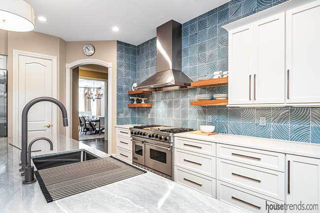 Quartz countertops complement kitchen backsplash
