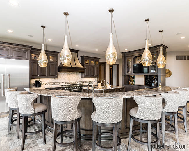 Glass pendants dangle over a kitchen island