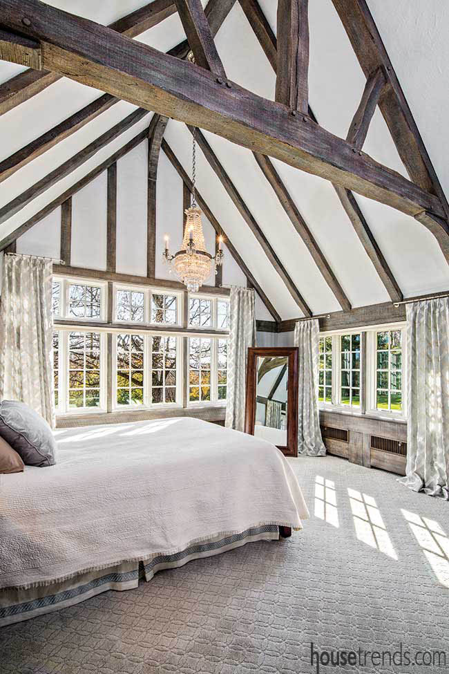 Exposed beams add interest to a master bedroom