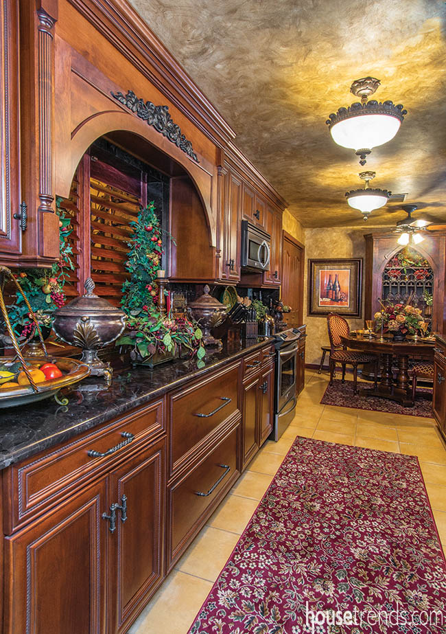 Cherry cabinets in a galley-style kitchen
