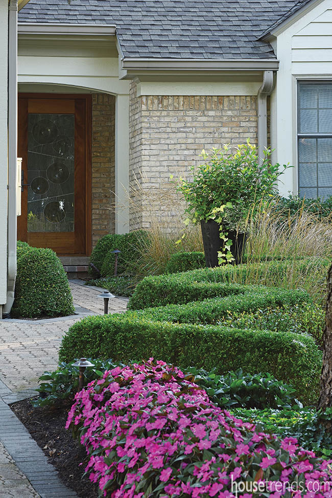 Eye-catching boxwood lines a pathway