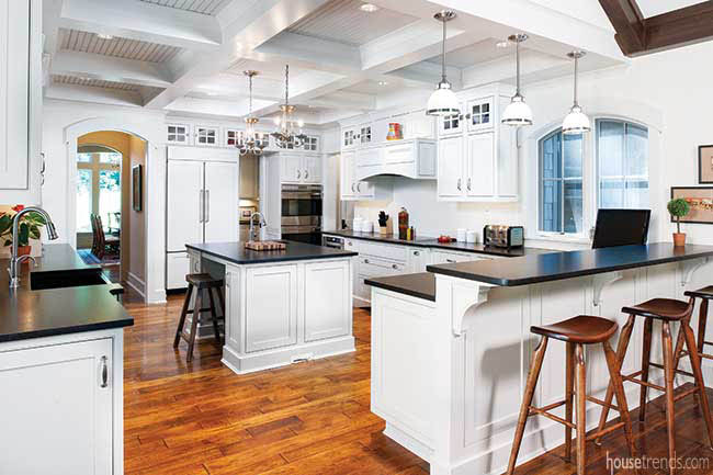Hickory floors run through a white kitchen