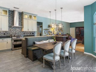Kitchen island and attached banquette steal center stage