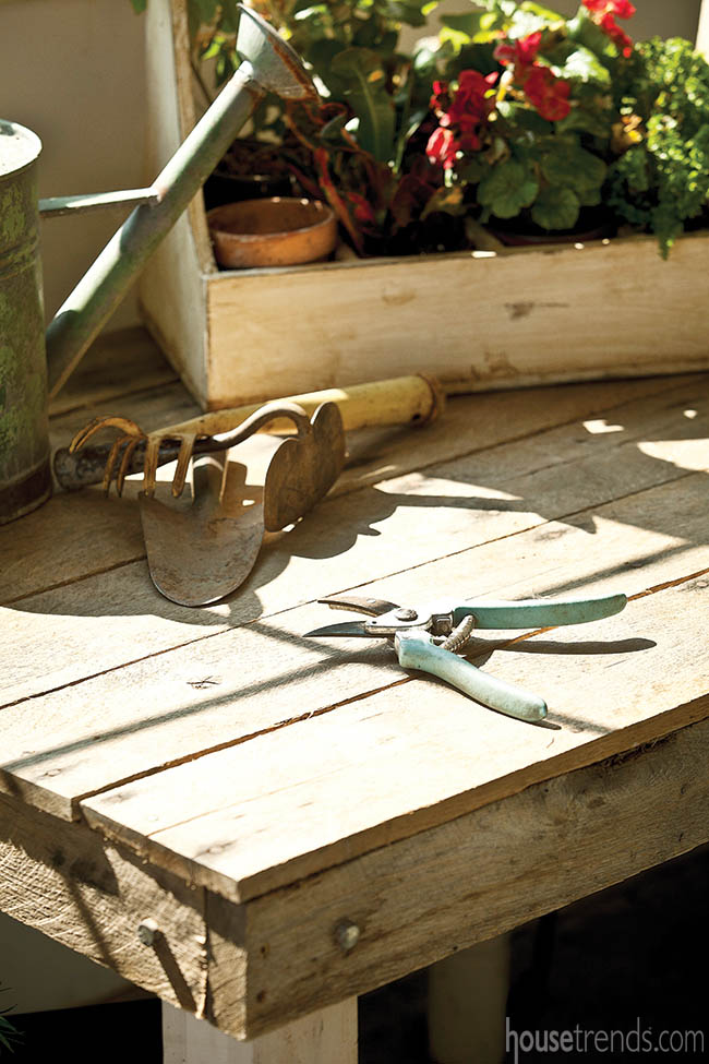 Rustic table doubles as a workstation in a garden shed