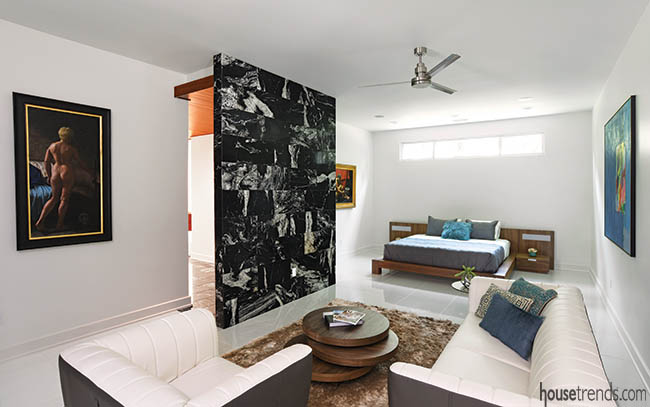 Black granite visually connects a master bedroom and bath