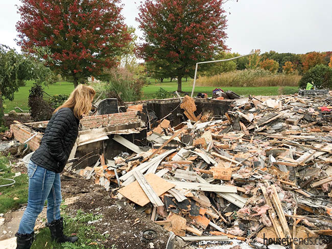 Owner peers at demolished home