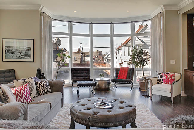 Barcelona chairs fit into the curve of a cantilevered window