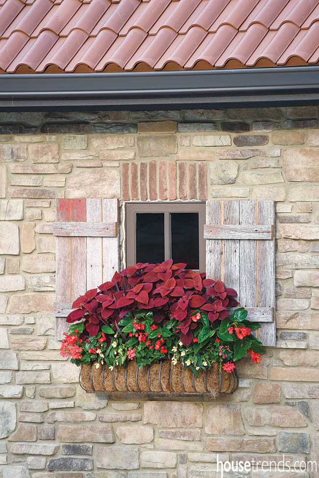 Charming window box and shutters soften a pool house design