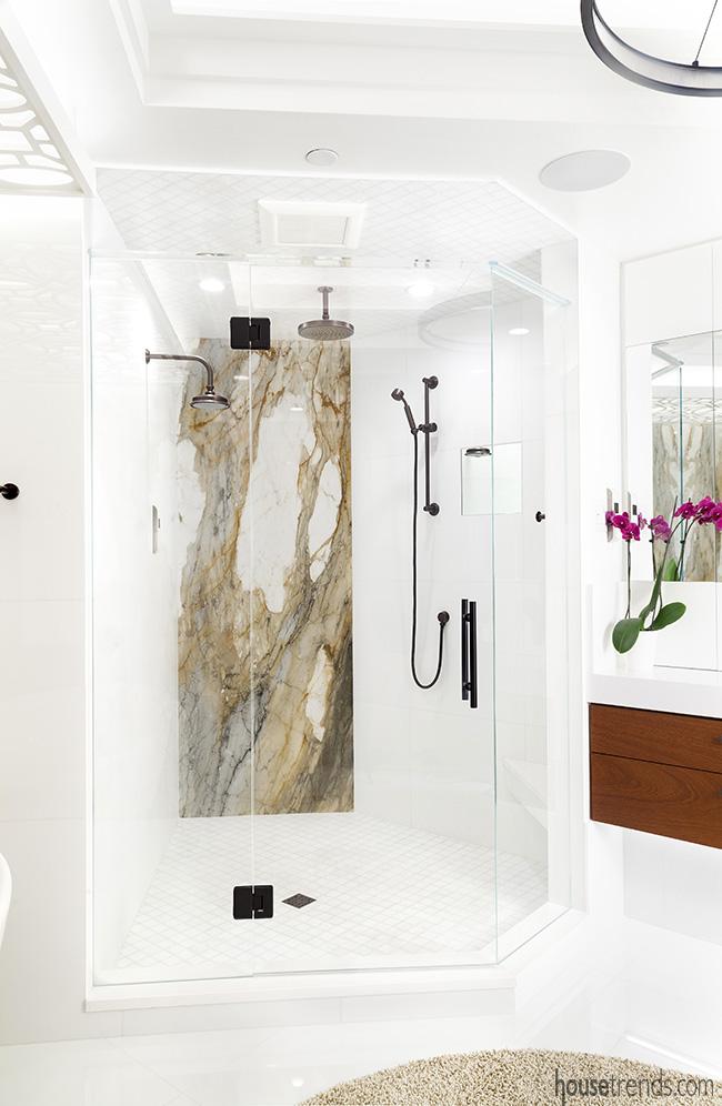 Dark bronze plumbing fixtures add character to the shower in this bathroom remodel