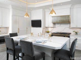 Gold pendant lights pop in a kitchen