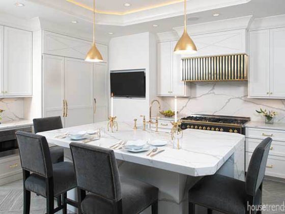 Gold pendant lights pop in a kitchen