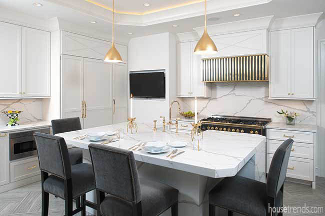 Gold pendant lights pop in a kitchen
