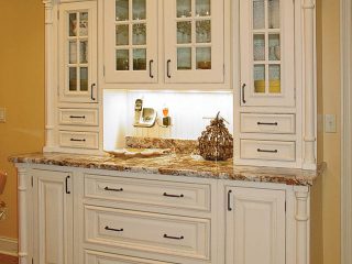 White kitchen cabinetry showcases glassware