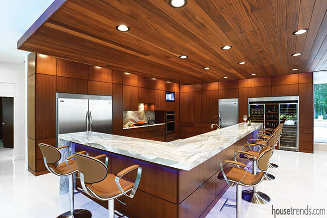 Cherry cabinets blend with a ceiling treatment