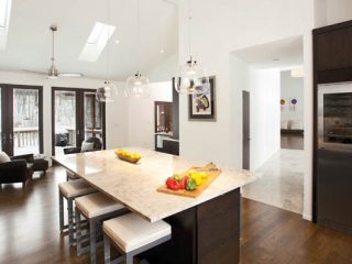 An island topped with a granite countertop provides the perfect place for party prepping