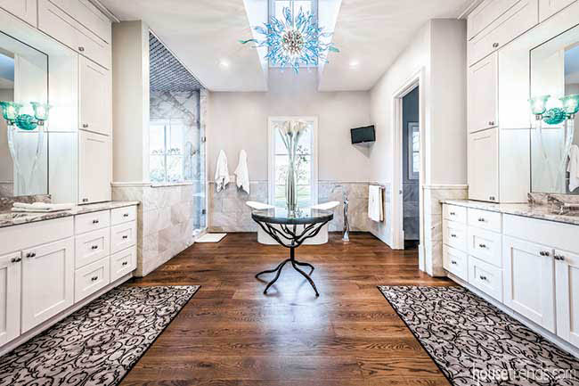Master bath with a blue glass chandelier
