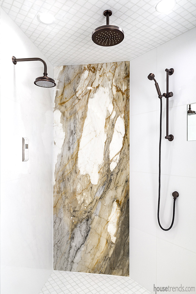 A dark bronze rain showerhead hangs from the ceiling in this bathroom remodel.