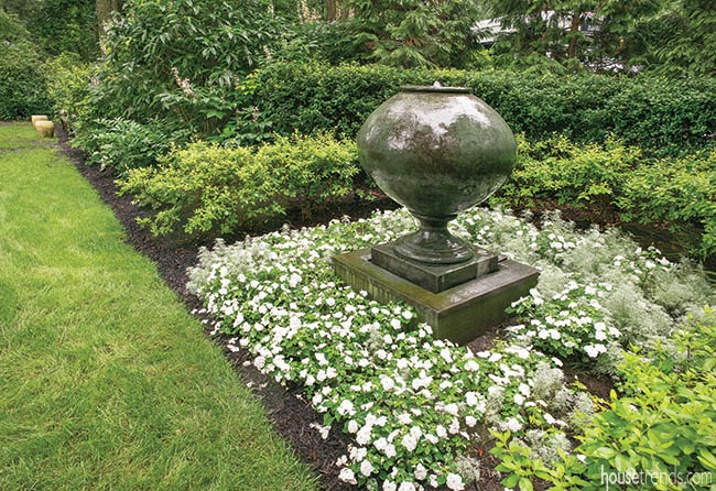 Flower bed hosts a shpere-shaped water feature