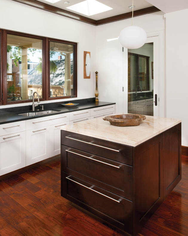 Stained maple cabinets help to make the island cabinetry pop