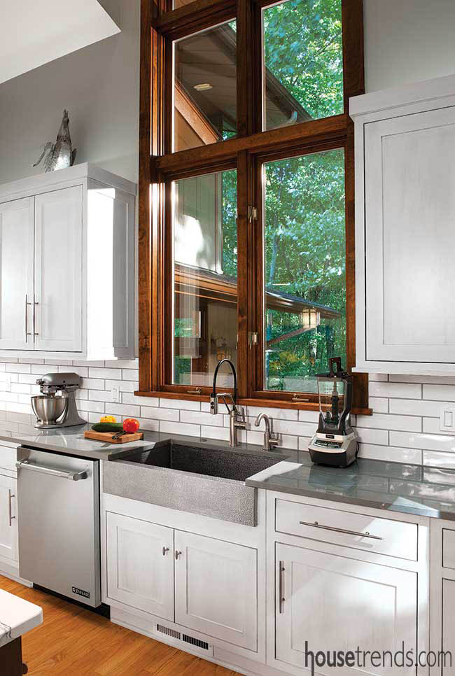 Gray grouting cuts through a white kitchen backsplash
