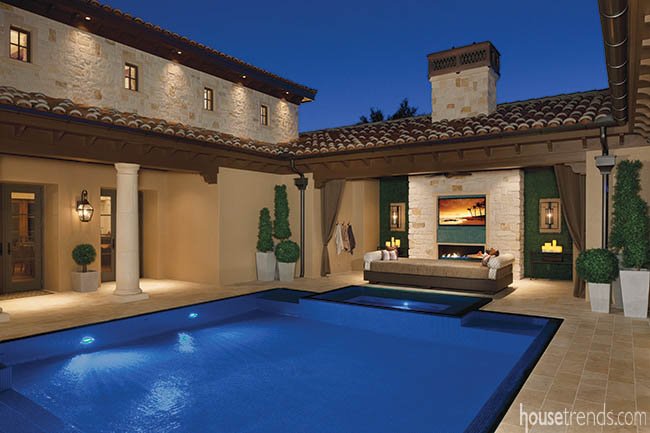 Outdoor fireplace and television complete an outdoor den