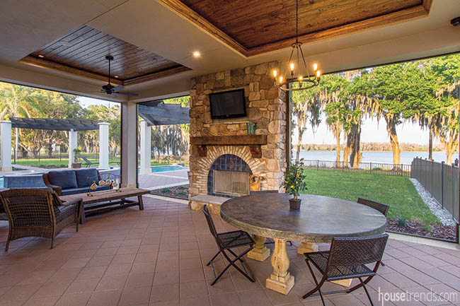 Stone fireplace warms up a covered lanai