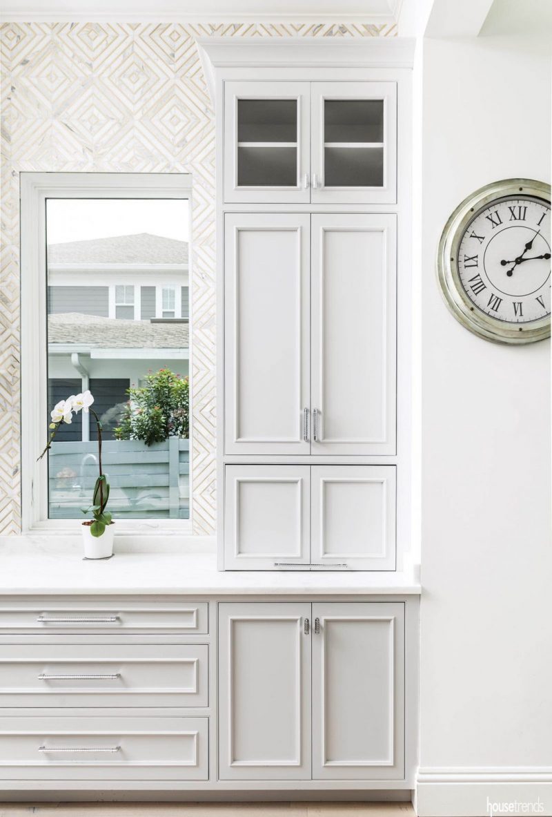 Chrome hardware shines against gray cabinetry