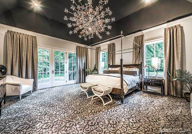 Crystal chandelier illuminates a master bedroom