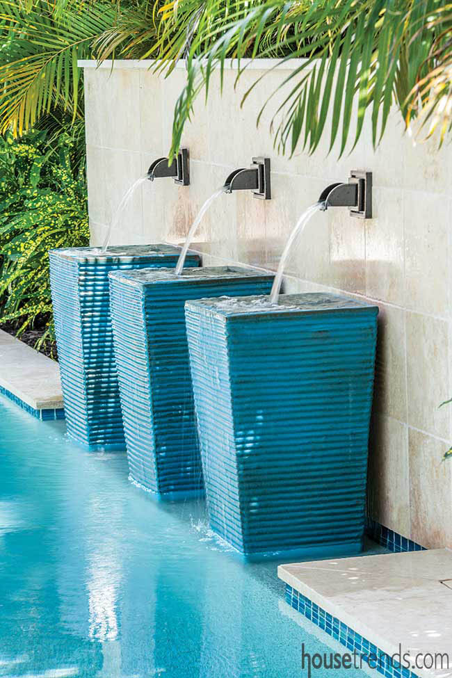 Outdoor fountains line a pool