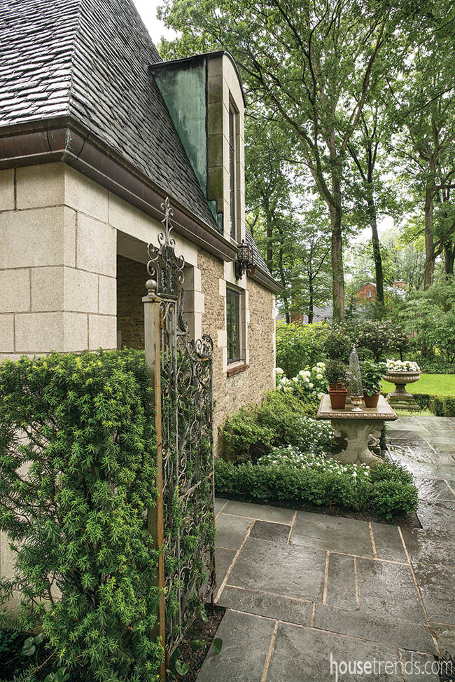 Elegant iron gate welcomes guests to a garden