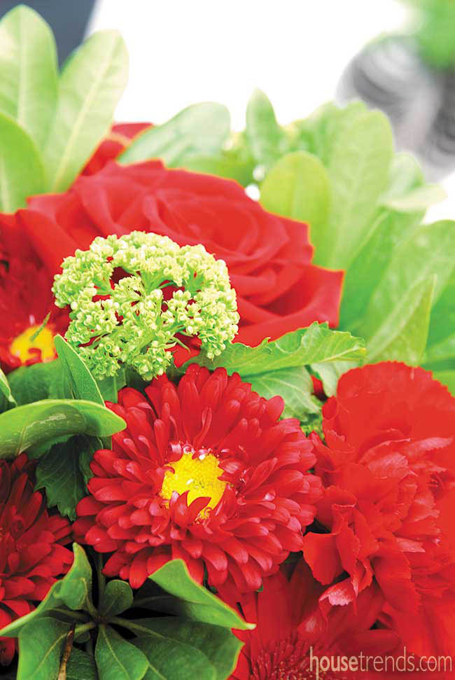 Red flowers add color to a table setting