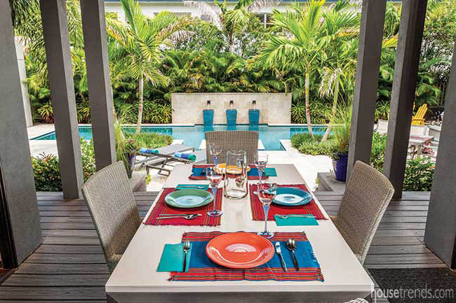 Outdoor dining area overlooks pool and patio