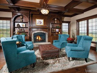 Teal armchairs pop in a cozy hearth room