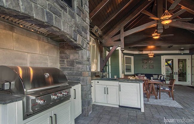 Outdoor cabinetry provides storage in grilling area