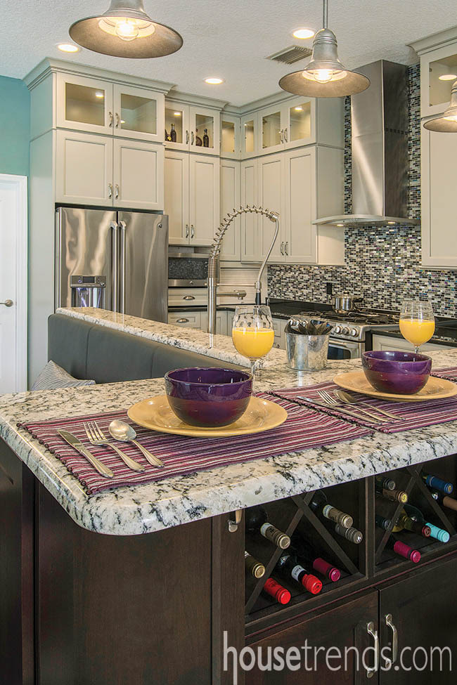 Kitchen island tucks away a home wine bar