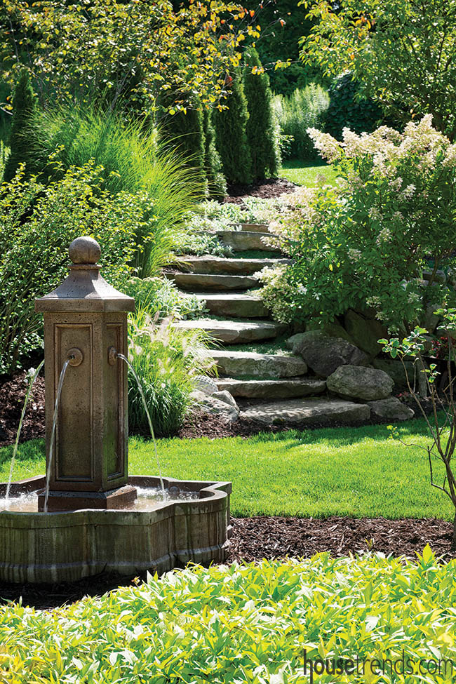 Water fountains serve as focal points in a back yard
