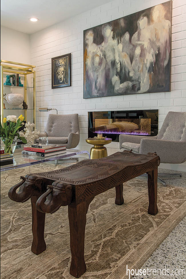 Living room boasts Jonathan Adler chairs