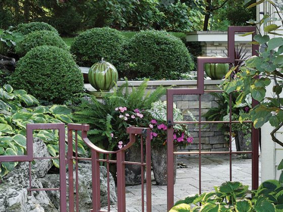 Steel gate with copper coloring adds elegance to a yard