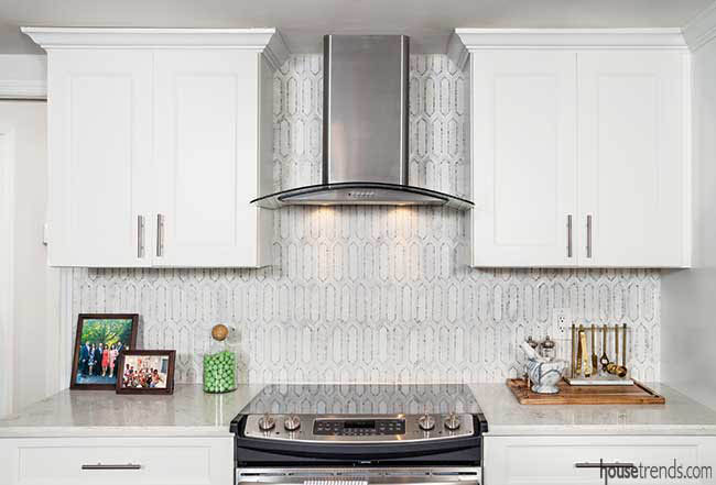 Marble backsplash complements a white kitchen