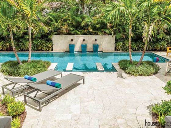 Lap pool runs through a back yard