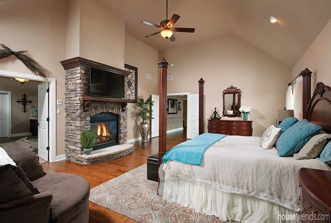 Stone fireplace heats up a master bedroom