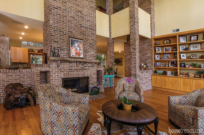 Brick fireplace separates kitchen and living room