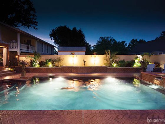 Nighttime swim illuminated by outdoor lighting