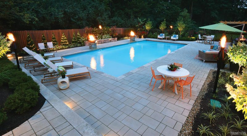 Privacy fence surrounds a back yard pool