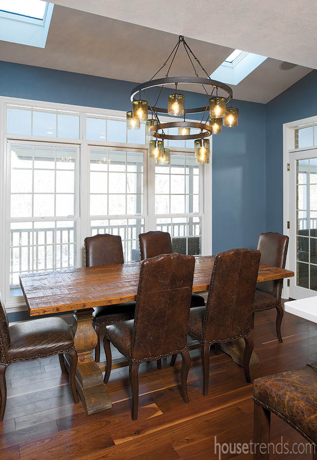 Rustic wood table dominates a formal dining room